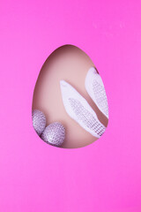 Easter egg cut out of paper and bunny ears with eggs. Easter holiday concept