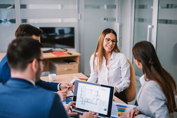 The economists having meeting at boardroom and doing statistics.