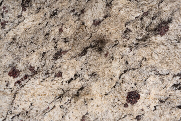 Tile texture with cream coloring and dark stains. Top view