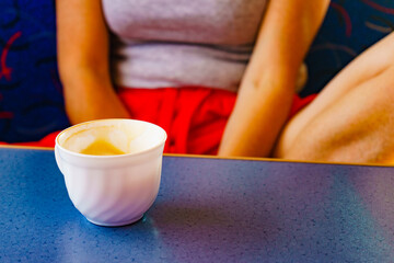Woman at table drinking Ccoffee