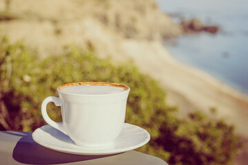 Coffe cup against sea beach.