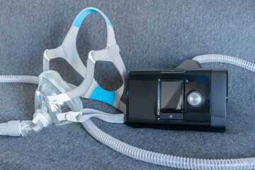 CPAP mask with a full face mask cpap machine against obstructive sleep apnea helps patients as respirator mask and headgear clip for breathing medication in snoring sleep disorder to breath easier