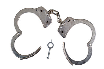 Open metal police handcuffs with key isolated on a white background