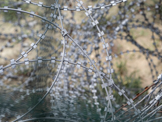 Illegal border with barbed wire crossing. The flow of refugees. Forced migration concept
