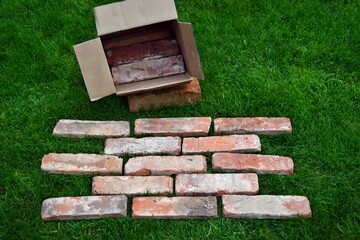 Cut red bricks range in cardboard box