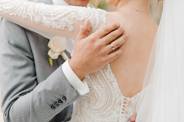 The groom holds the bride's hand. The guy holds the girl's hand