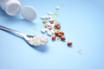 Nutritional supplements, vitamins and nutraceuticals on blue background.