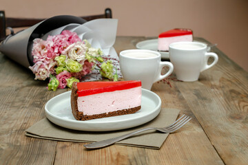 red jelly cheesecake, sweet dessert with flowers, cup of coffee on wooden table background. gift to woman on March 8 holiday, valentine's day breakfast food, international Women's Day