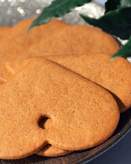 Heart-shaped gingerbreads on a plate. Christmas cookies. Christmas background.