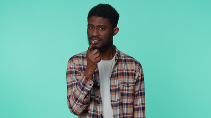 I am warning you. Bearded african american man shakes finger and saying no, be careful, scolding and giving advice to avoid danger mistake disapproval sign. Upset guy isolated alone on blue background