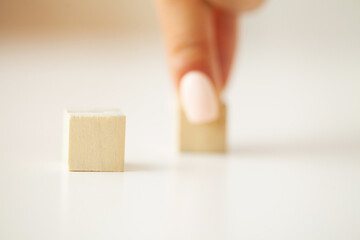 Hand arranging wood block with empty space