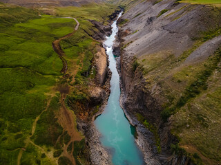 Beautiful aerial view of the studlagil canyon, and the largest number of basalt rock columns in...