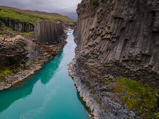 Beautiful aerial view of the studlagil canyon, and the largest number of basalt rock columns in...