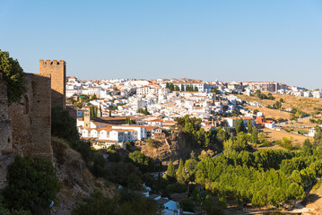 Fototapeta na wymiar View of the famous white village of Ronda with the old wall in the foreground at daylight, Malaga province, Andalusia, Spain