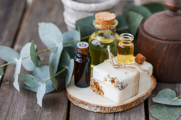 Assortment of natural oils in glass bottles on wooden background. Concept of pure organic ingredients in cosmetology. Bath accessories, atmosphere of harmony, relax. Close up macro. Healthy lifestyle