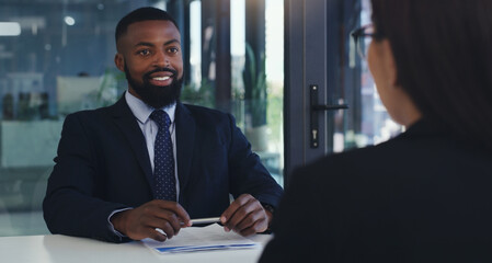 Im excited to hear more from you. Shot of a young businessman having a meeting with a colleague in an office.