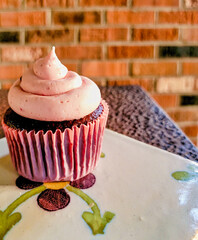 cupcake with buttercream frosting and cherry compote filling