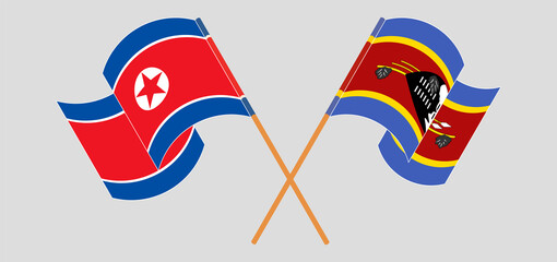 Crossed and waving flags of North Korea and Eswatini