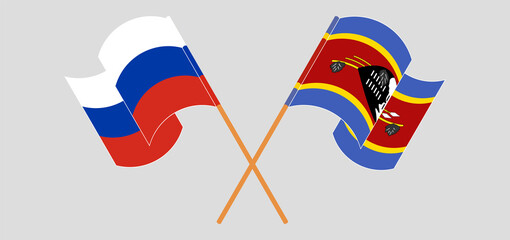 Crossed and waving flags of Russia and Eswatini