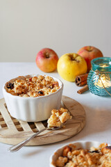 Apples with crumble and cinnamon. Baked apples in a ramek. Autumn apples. Blue lantern with a candle. Autumn photo. Food photography.