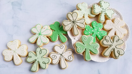 st. patrick's day sugar cookies on a platter with a marble background