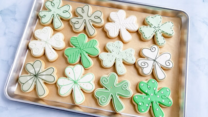 st. patrick's day sugar cookies on a brown parchment lined cookie tray
