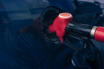 Pumping gasoline fuel nozzle to refuel. Vehicle fueling facility at petrol station. Car at gas...