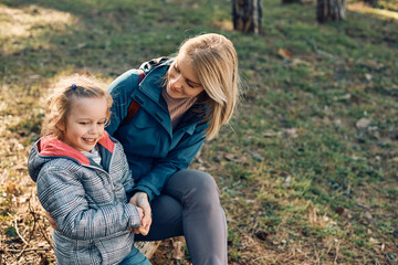 Obraz na płótnie Canvas Happy mother and daughter talk while relaxing in nature.