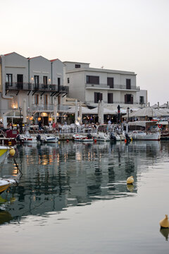  Waterside restaurants in early evening light at Old Venetian Harbor in Rethymnon. Crete, Greece