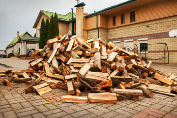 A pile of split firewood for heating the house.