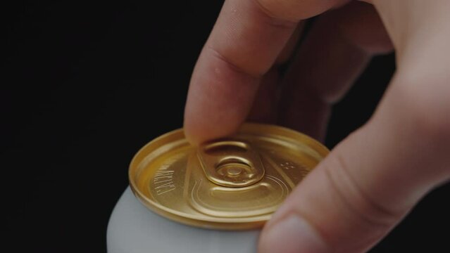 Close up. a hand opening soda or beer can. Can pull tab opening 100fps