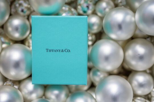 Calgary, Alberta - March  8,, 2022: Tiffany & Co. gift box on christmas bulb background.