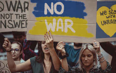 Image composition to illustrate pacifists young people protesting against the war aggression...
