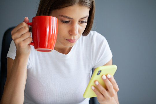 The Young Woman Does Not Look Away From The Phone