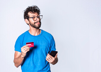 man with credit card and cell phone in hand, cheerful guy with cell phone and bank card, bank payment concept