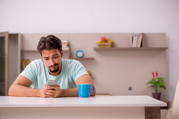 Young man watching tv at home