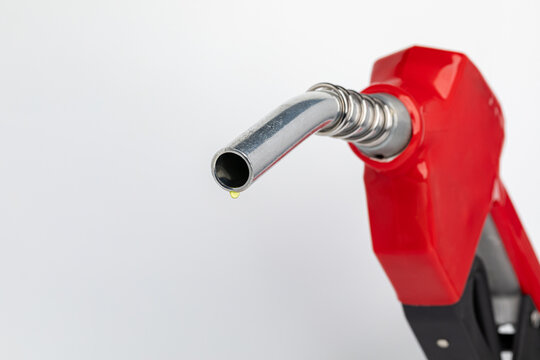 Gas dripping from fuel nozzle. Gasoline shortage, price and ethanol concept.