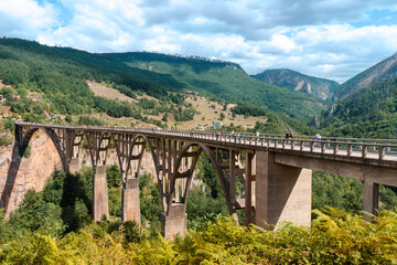 Fototapeta na wymiar Djurdjevica Tara Bridge over a mountain river in Montenegro