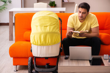 Young man looking after new born at home