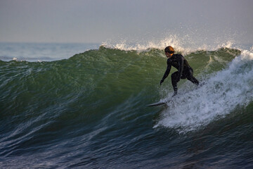 Surfing Rincon point in California in the winter at sunset