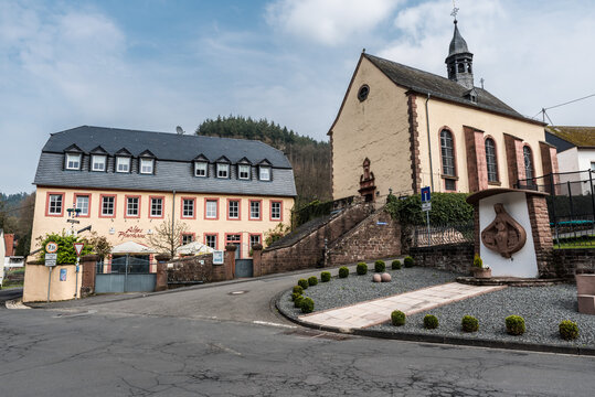 Auw An der Kyll, Rhineland-Palatinate - Germany - Scenic view over the church, square and small park of the village at the German countryside