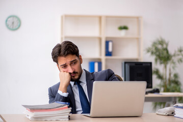 Young male employee working in the office