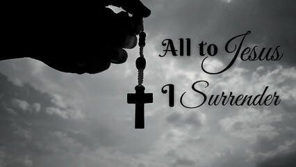 Christianity inspirational message - All to Jesus I surrender. With hand holding Rosary and sky...
