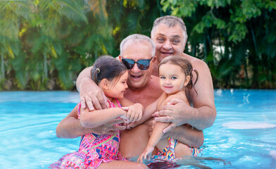 Portrait of grandfather and great-grandfather with children