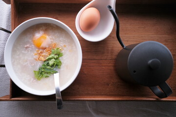 Top view of the traditional Thai breakfast set in wooden tray on table, tasty morning meal, hot...