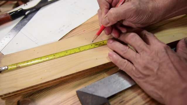 carpenter measuring wood