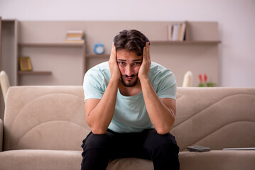 Young man sitting on the sofa