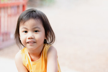 Asian girl, little preschooler child smiling and looking at camera.
