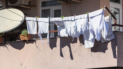 A stone  house in an turkish  city, laundry is drying on a rope