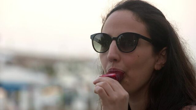 Young woman licks ice cream - travel photography